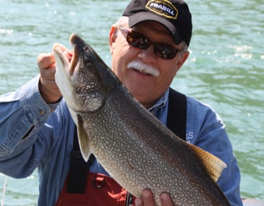 Don Dziedzina hoists a beautiful 20-pound lake trout he pulled from the Niagara River in Western New York.